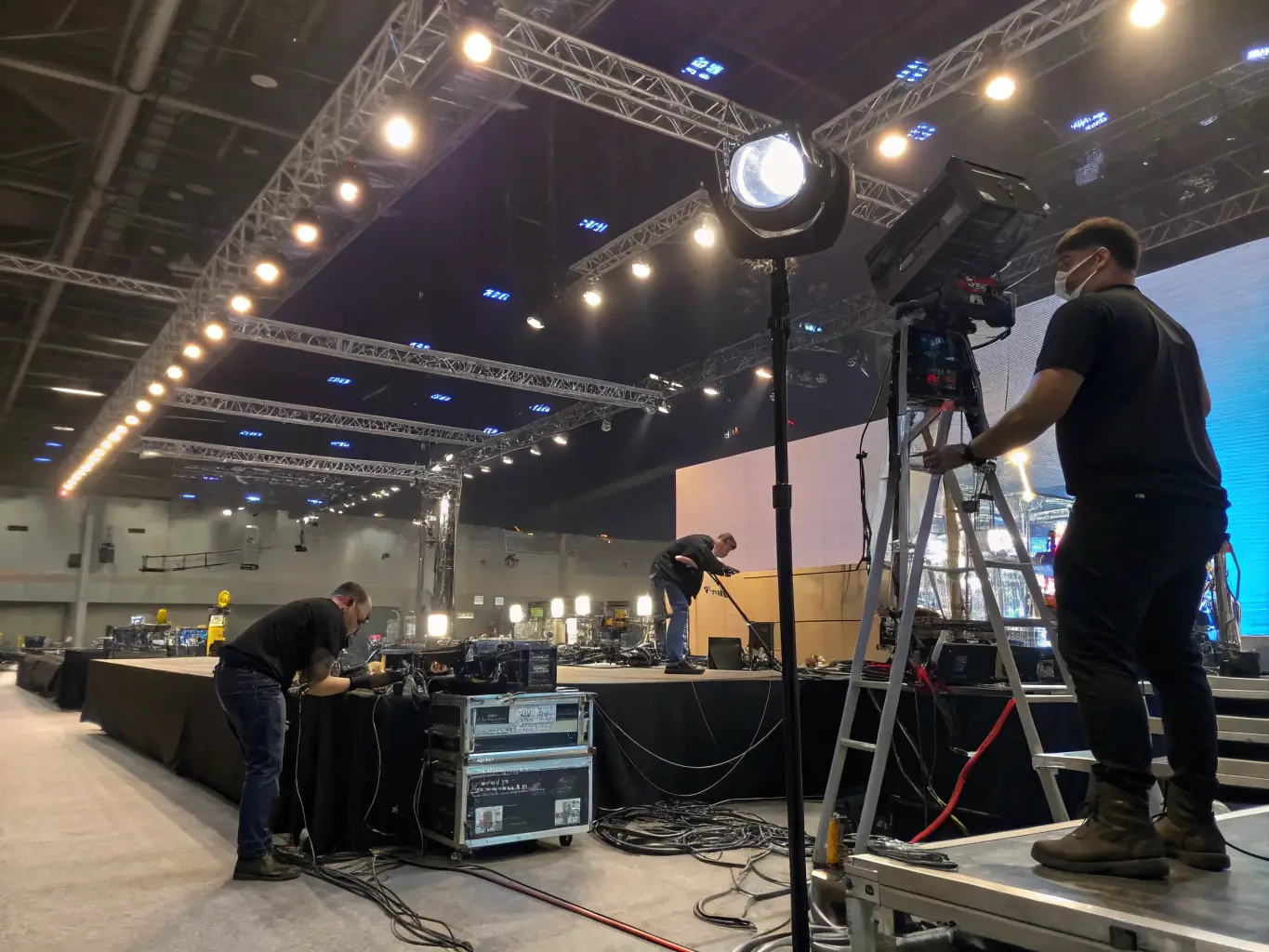 A skilled lighting technician adjusting stage lights during a theatrical performance, demonstrating DervLabs' attention to detail in creating visually stunning live events.